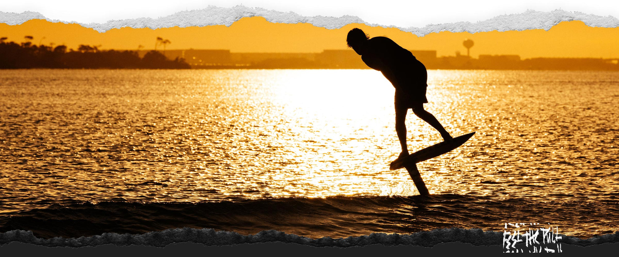 Silhouette of rider foiling on Legacy Horizon Surf foilset at sunset.
