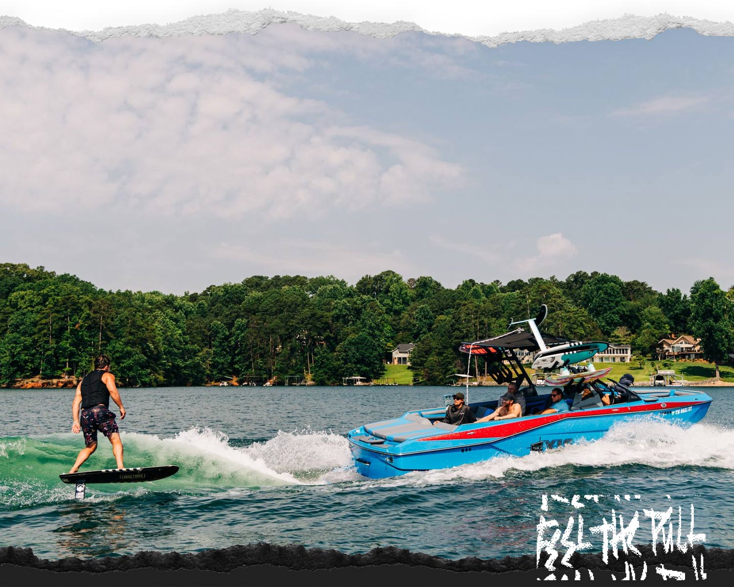Rider surf foiling behind blue boat using Legacy Horizon Surf foilset on lake.