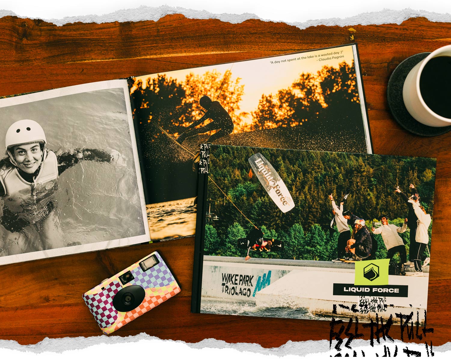 Overhead view of a wooden table featuring two wakeboarding books.