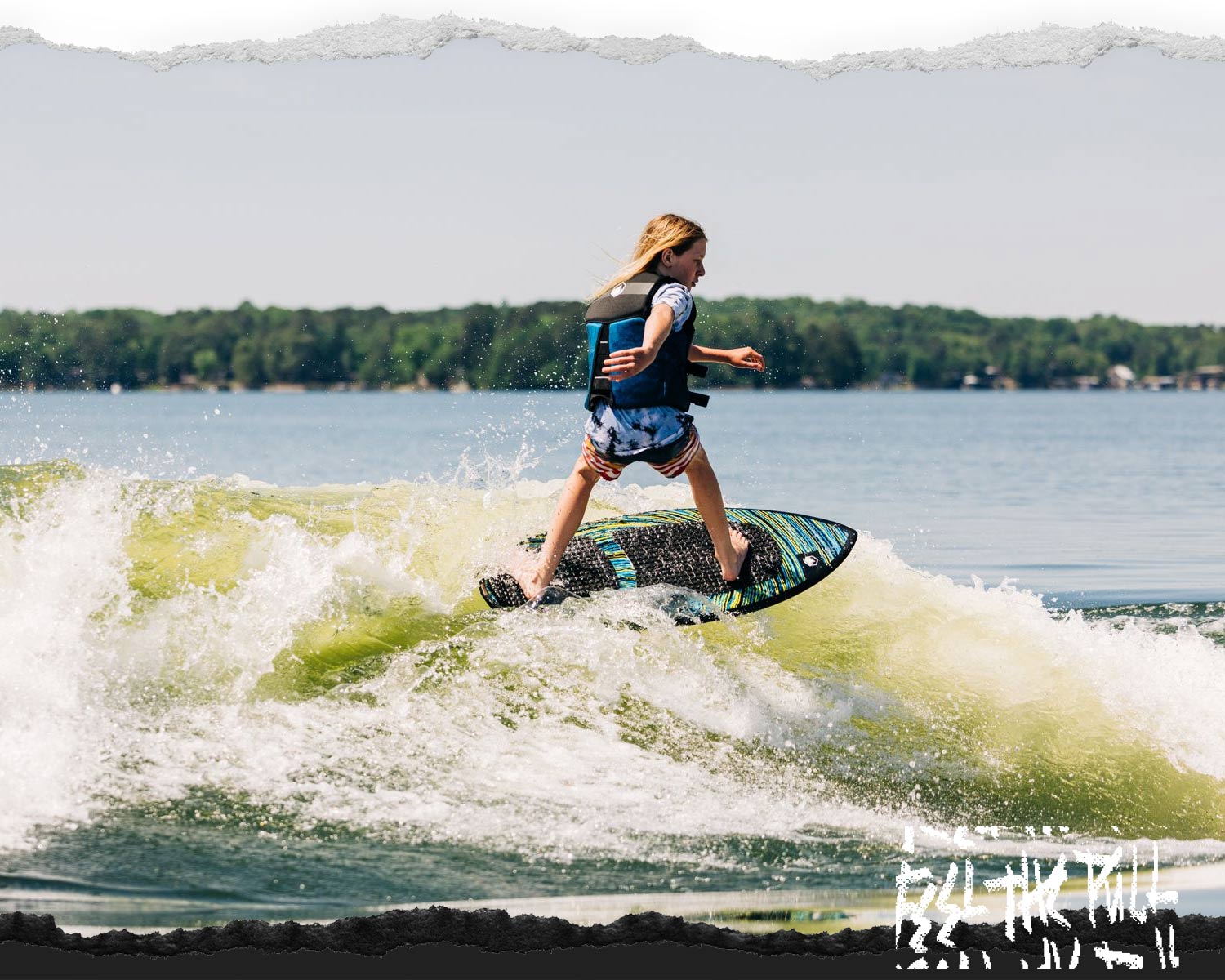 Young person riding the Liquid Force Primo FS Wakesurfer in a blue vest.