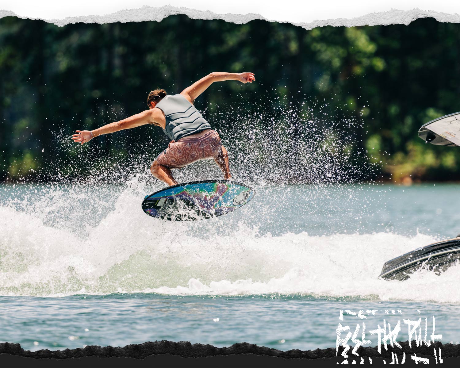 Rider landing a trick on the Liquid Force Reign Wakesurfer in a gray vest.