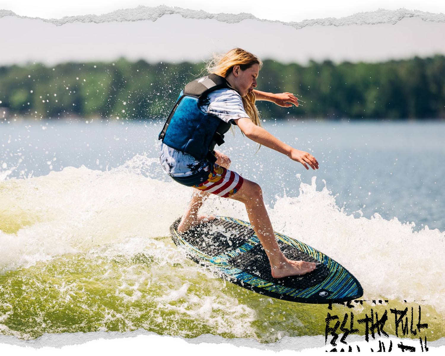Kid surfing on a black and blue wakesurf board while wearing a black Ruckus CGA vest.