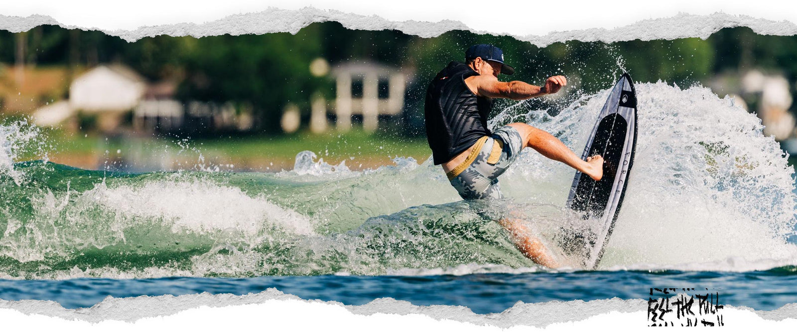 Wakesurfer turning on a wave in camo shorts and black Liquid Force vest.