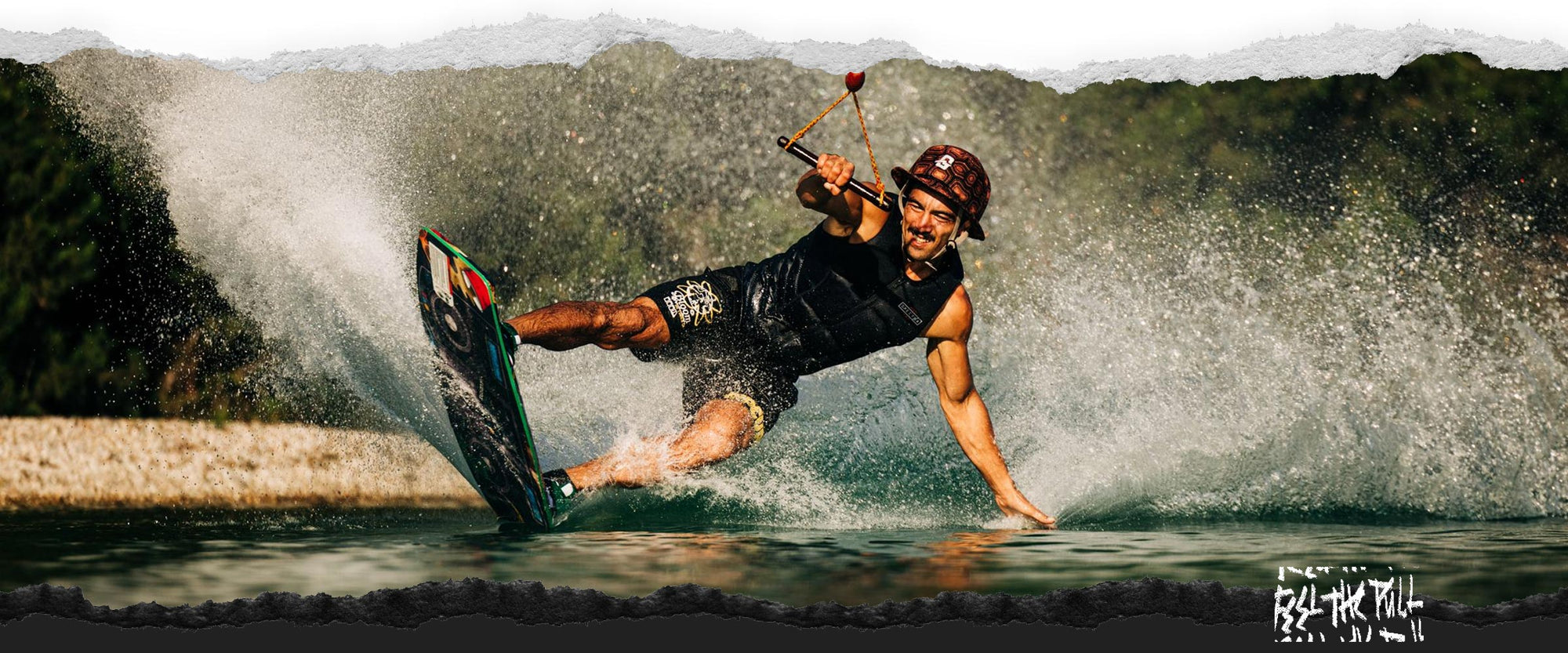 Rider in black vest carving hard on the Liquid Force Tao Wakeskate.