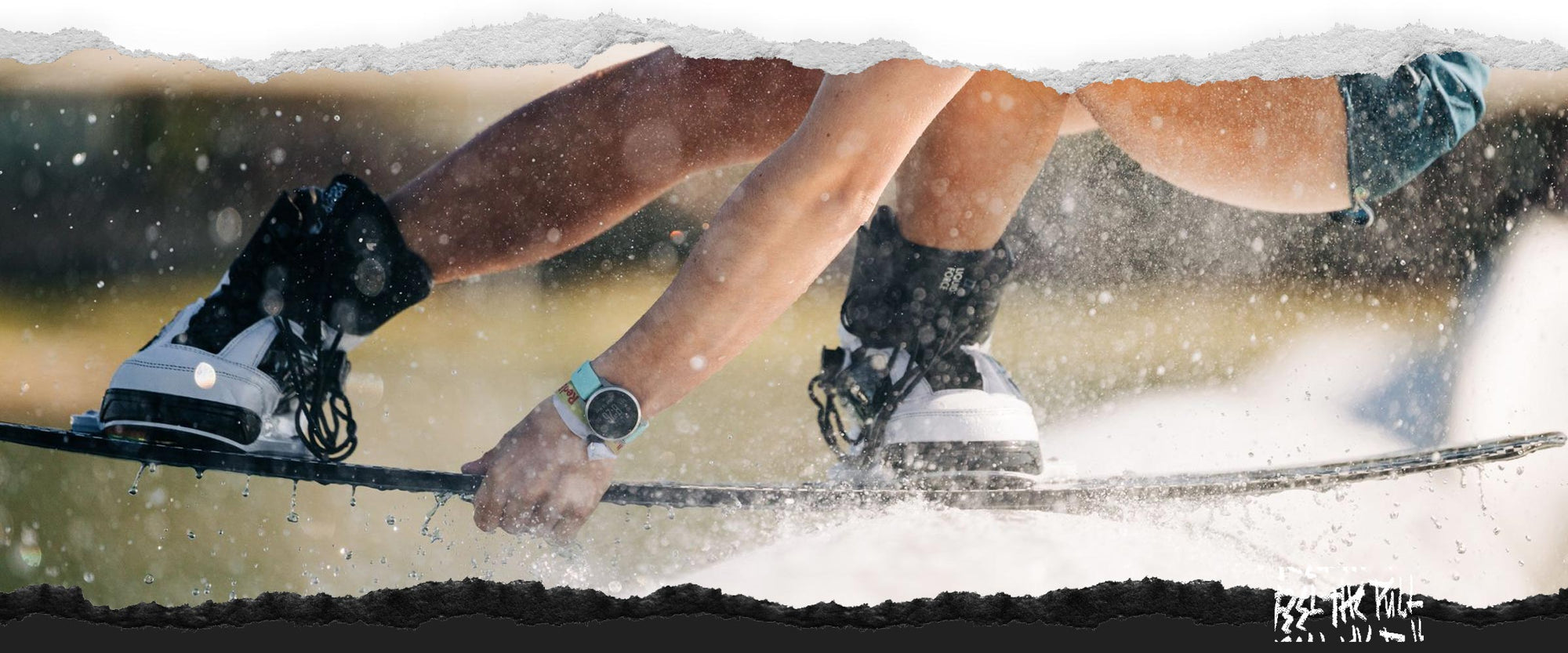 Rider presses down on rail in black and white bindings.