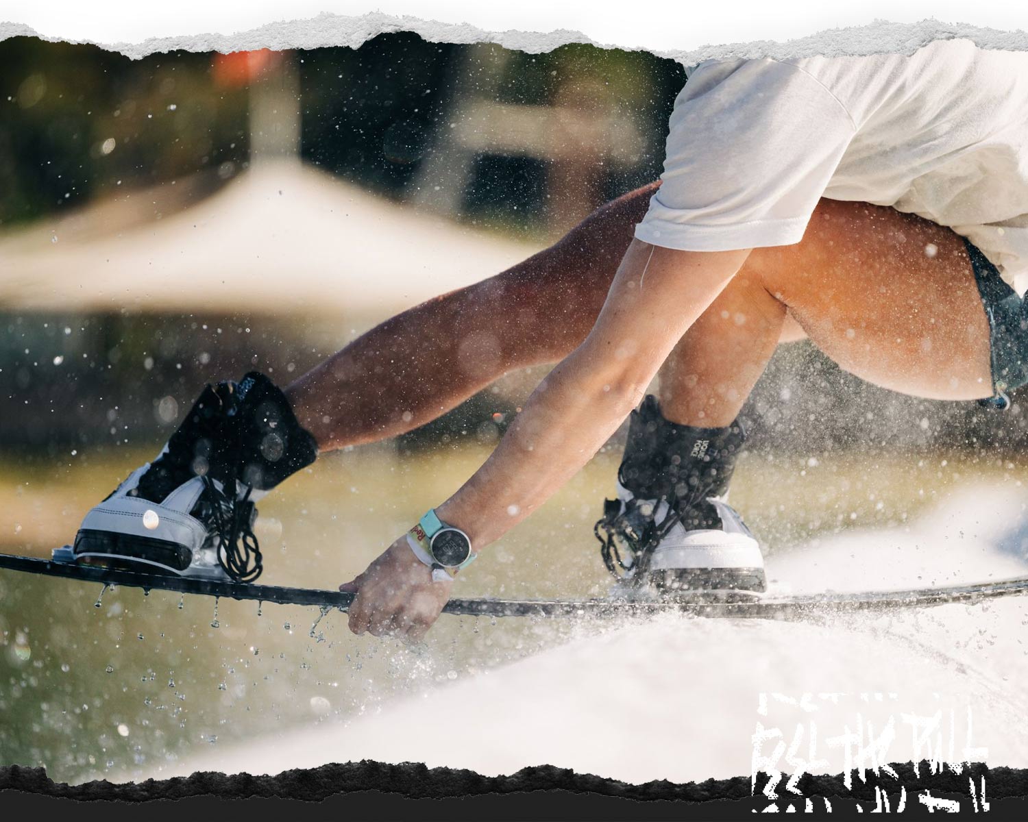 Rider presses down on rail in black and white bindings.