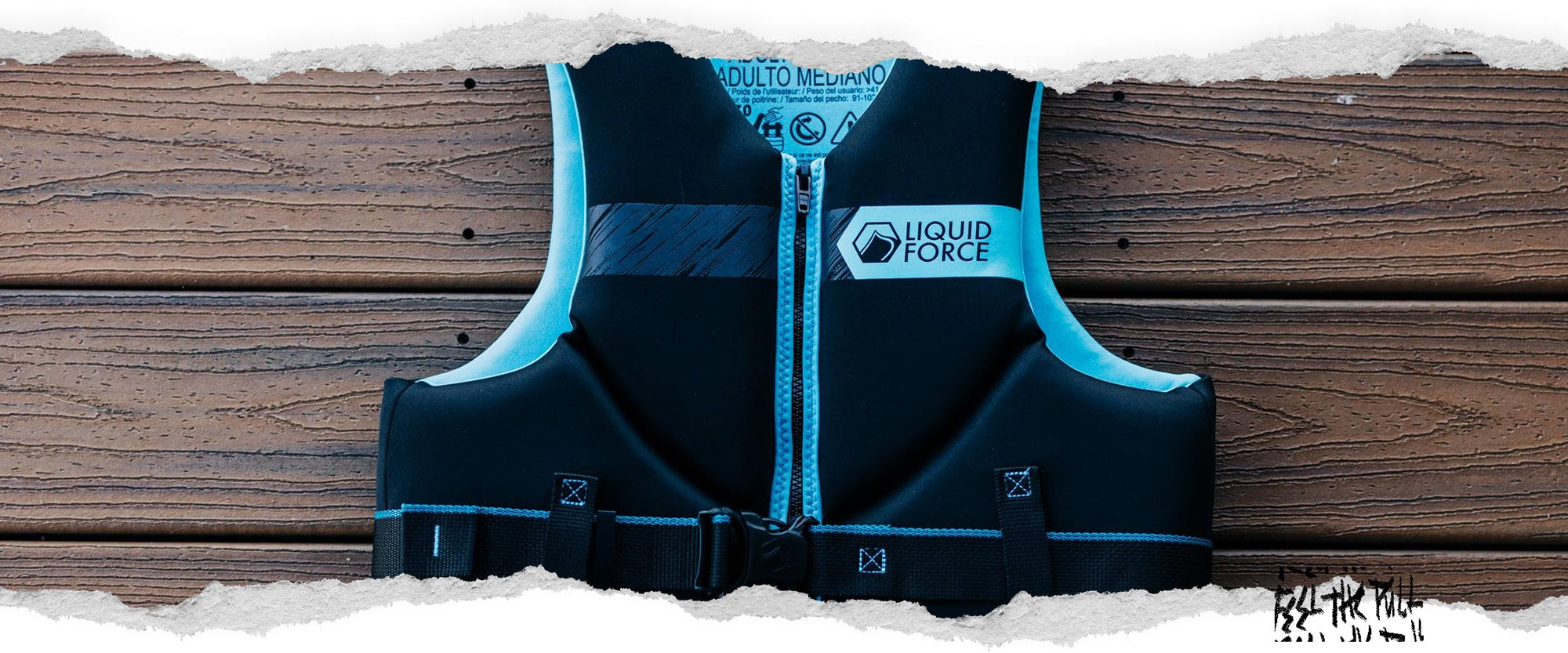 Black and aqua Classic Hinge CGA vest with Liquid Force logo laid flat on wood planks.