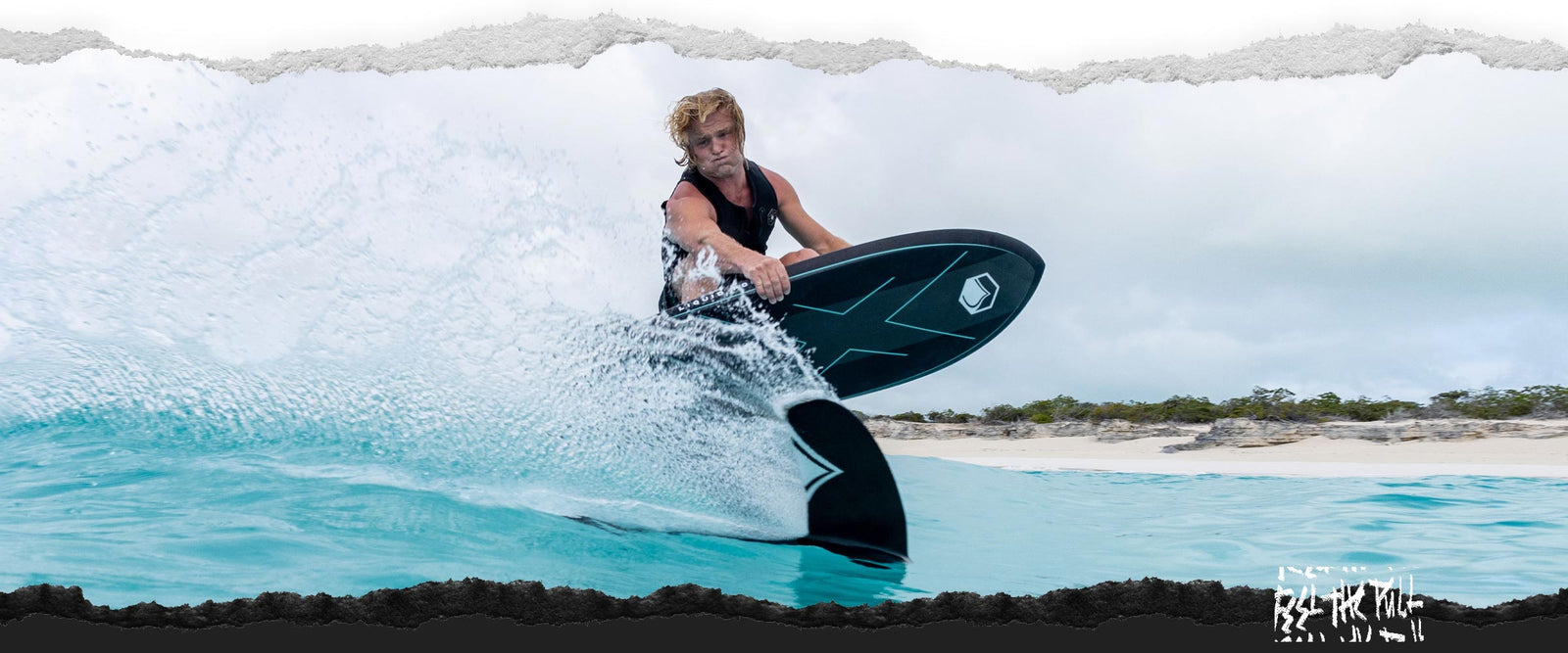 Surfer in black vest cutting across a wave on a black Liquid Force foil board.