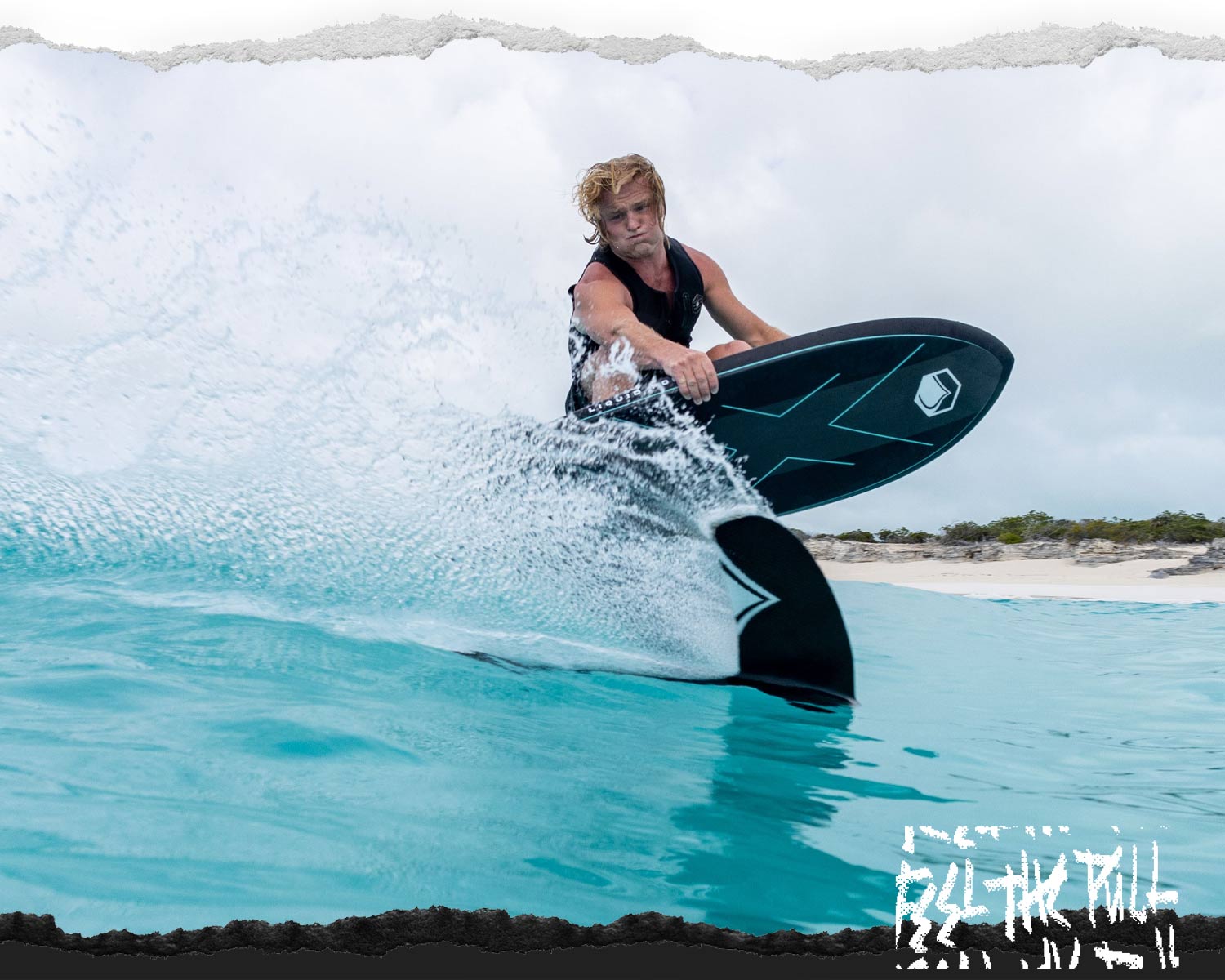 Surfer in black vest cutting across a wave on a black Liquid Force foil board.