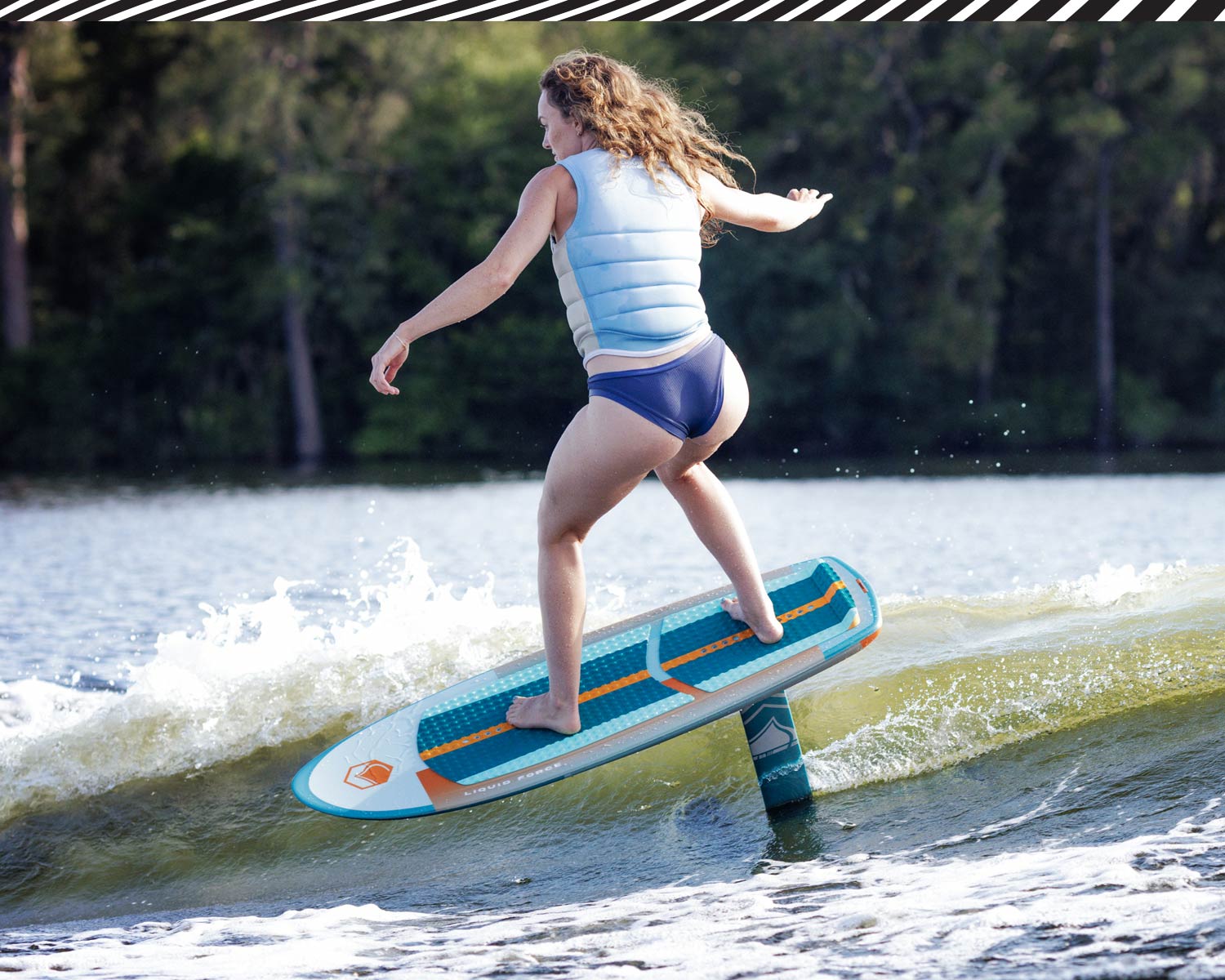 Rider glides on Horizon Surf foil setup above small wave in bright sunlight.