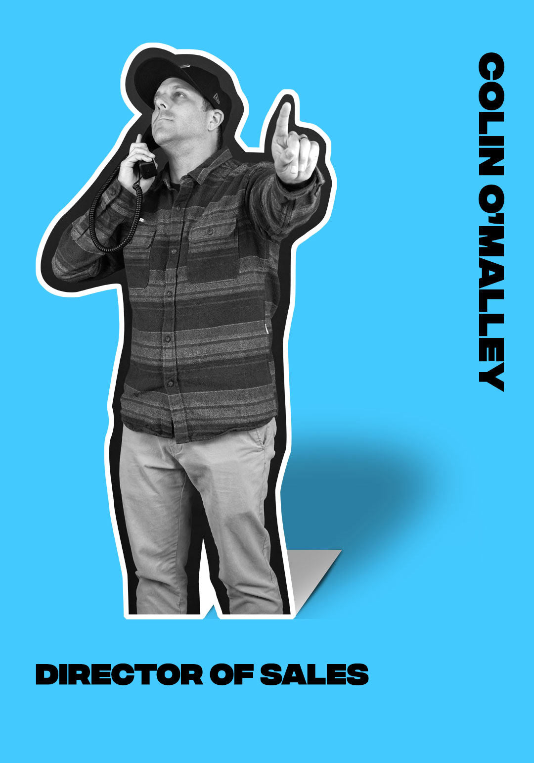 Colin OMalley, Director of Sales, points up with phone in hand.