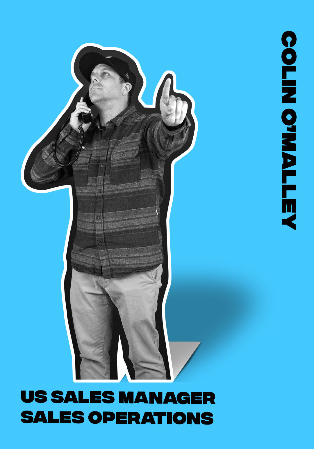 Colin OMalley, US Sales Manager, points up with phone in hand.