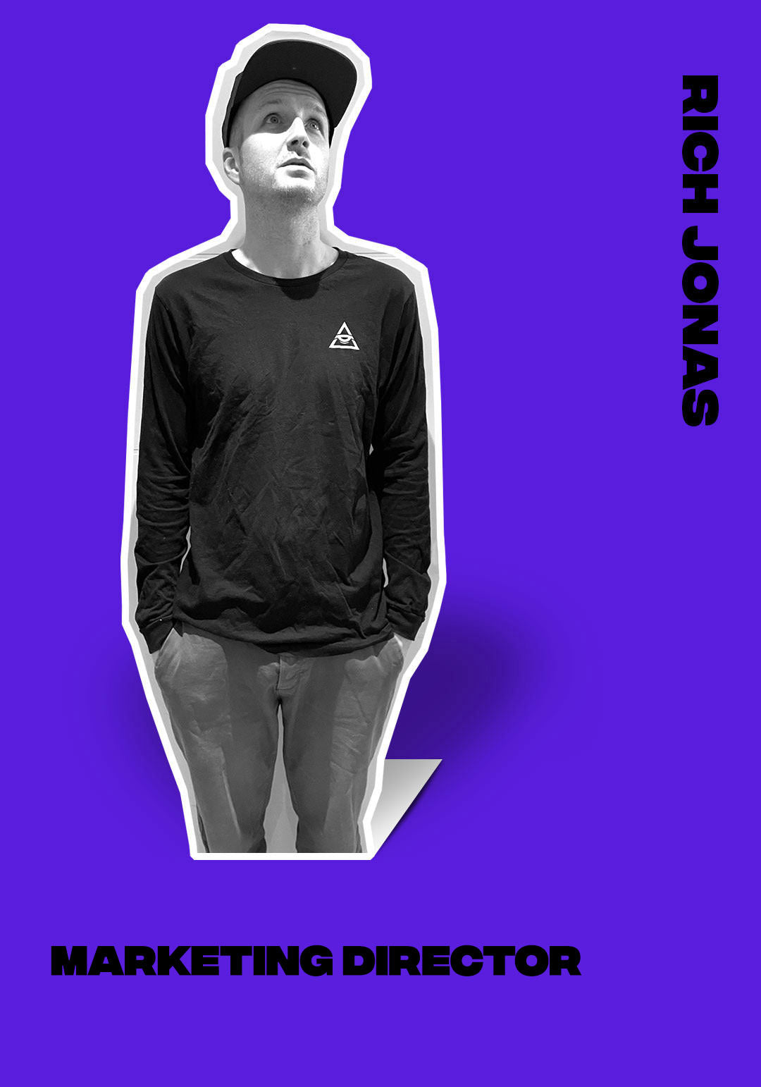 Rich Jonas, Marketing Director, in casual wear and a cap, standing against a vibrant purple.