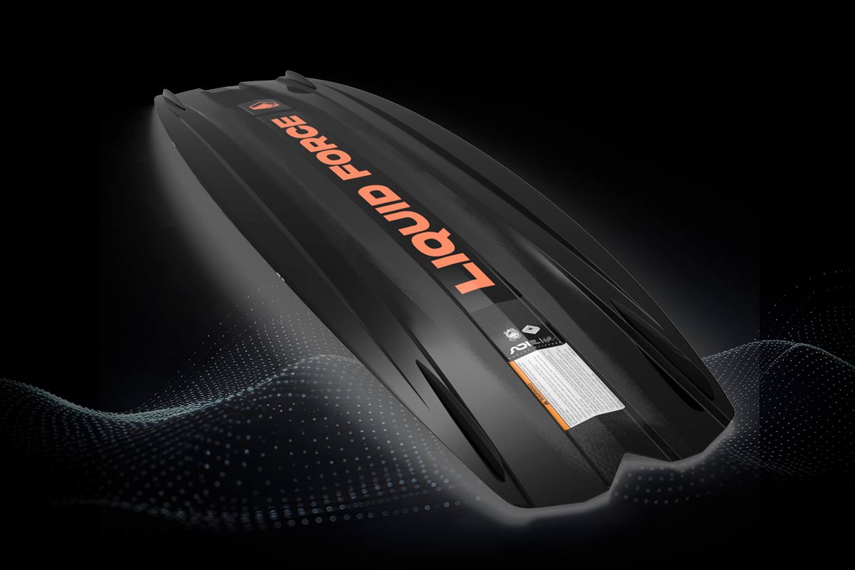 Bottom view of black Liquid Force wakeboard with orange logo and molded fins on black background.