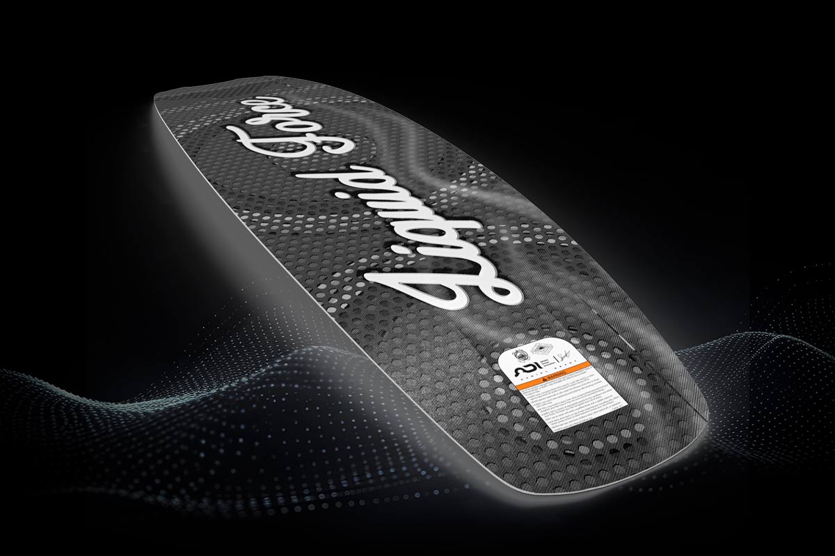 Angled view of black Liquid Force wakeboard with textured surface and white script logo.
