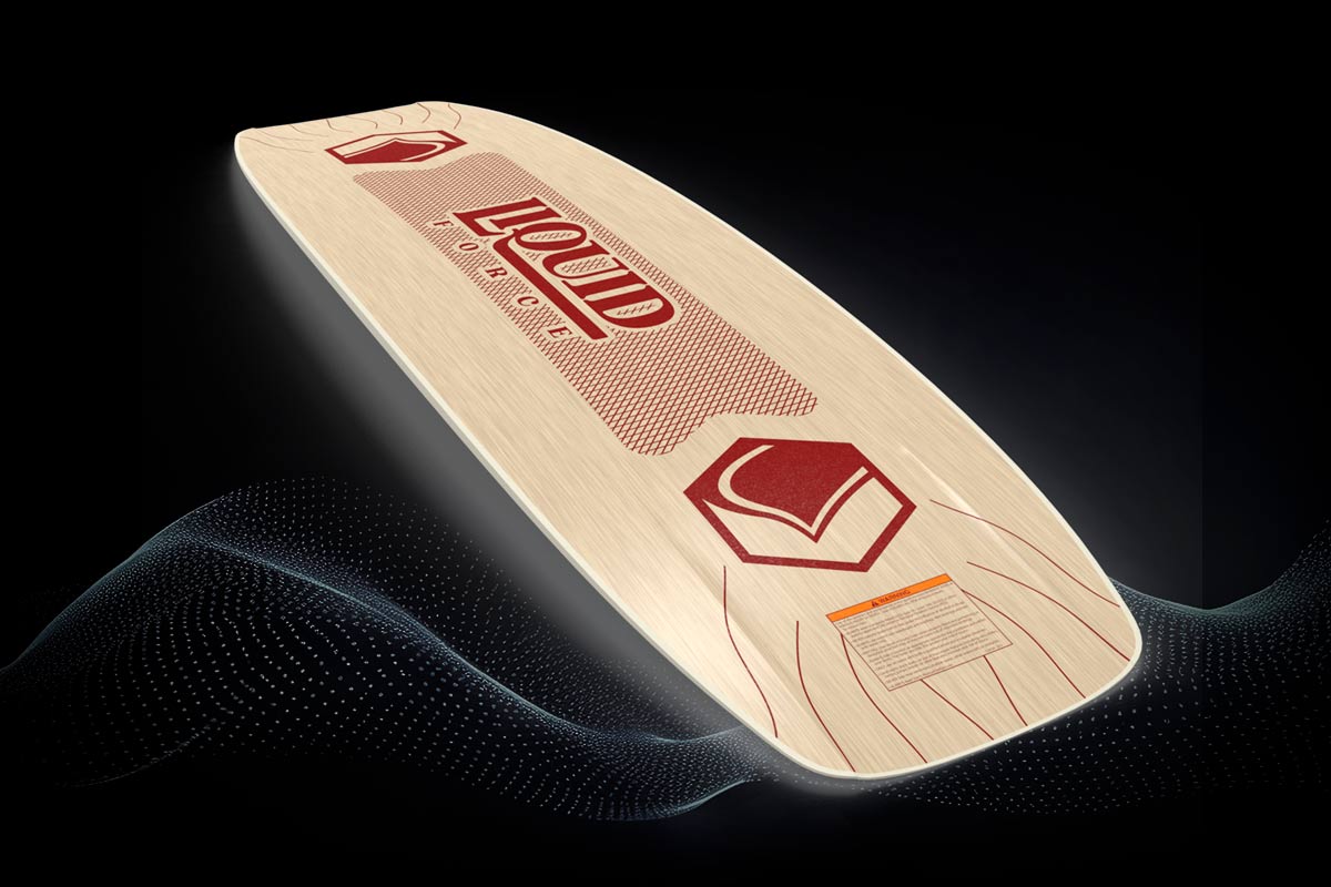 Angled view of wood grain Liquid Force wakeboard with red logo and stylized line graphics.