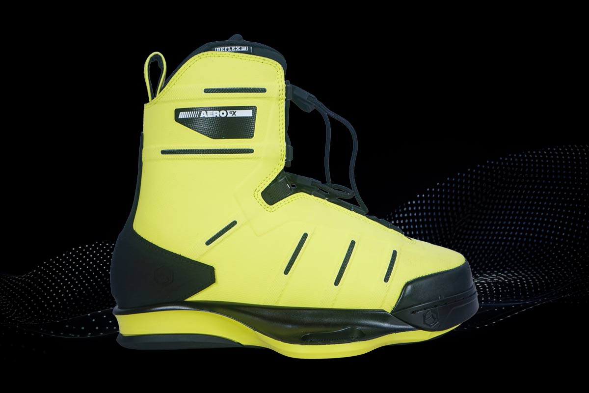 Yellow wakeboard binding with black accents on a black background