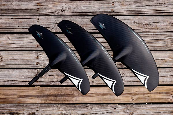3 sizes of LiquidForce carbon foils sitting on a wooden deck.